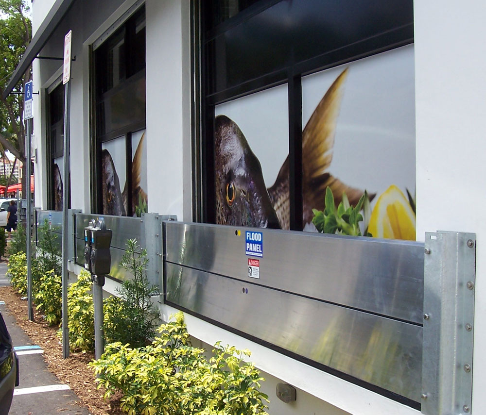 The new Sandwich Plate System Flood Panels by Flood Panel, LLC, similar in appearance to the panels pictured, are thinner and lighter than other flood barrier solutions for easy initial installation, deployment before a storm event and storage.